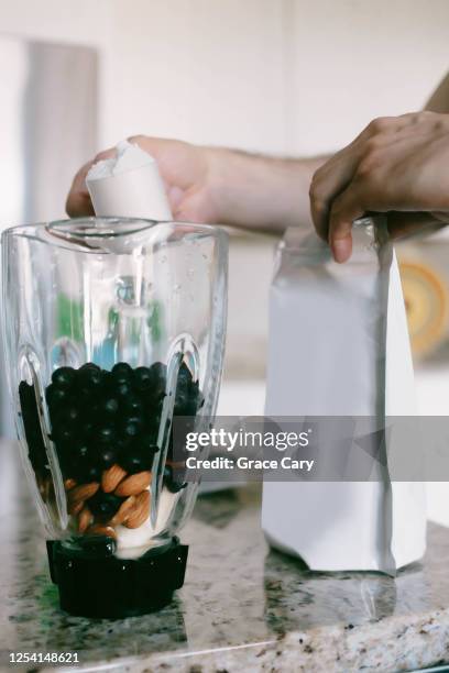 man prepares post-workout smoothie - post workout snack stock pictures, royalty-free photos & images