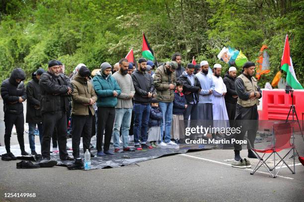 Muslims from the local community block the road and pray outside UAV Tactical Systems in solidarity with Palestine Action on day twelve of the siege...