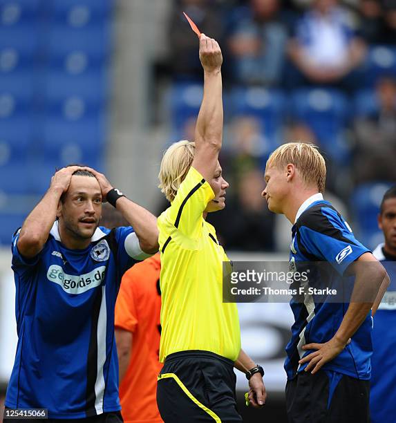 Referee Bibiana Steinhaus shows the red card to Manuel Hornig of Bielefeld while Markus Schuler of Bielefeld reacts during the Third League match...