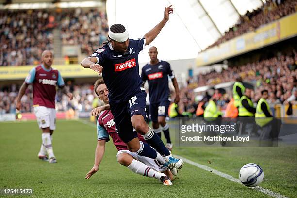Tamika Mkandawire of Millwall takes on the West Ham United defence during the npower Championship match between Millwall and West Ham United at The...