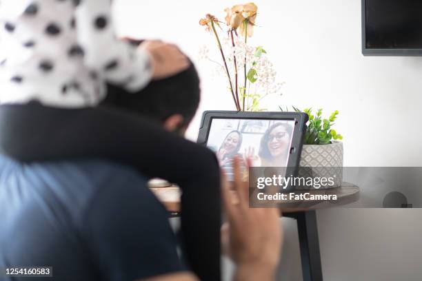 man and daughter video chat with grandma and family from home - middle eastern male on phone isolated stock pictures, royalty-free photos & images