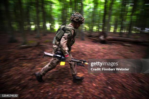 Soldiers attack enemy positions in woodland during a training exercise on Salisbury Plain Training Area on July 03, 2020 in Salisbury, England. 5...