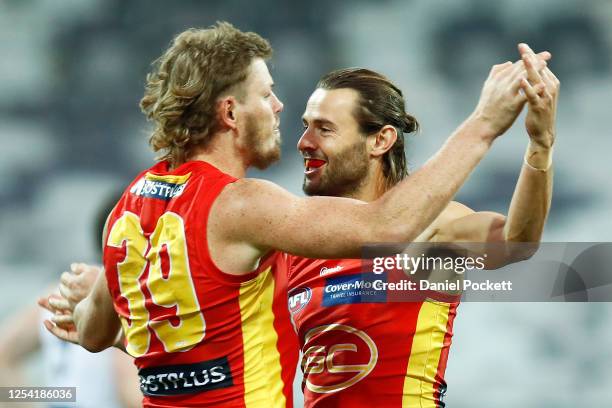 Lachie Weller of the Suns celebrates after kicking a goal during the round 5 AFL match between the Geelong Cats and the Gold Coast Suns at GMHBA...