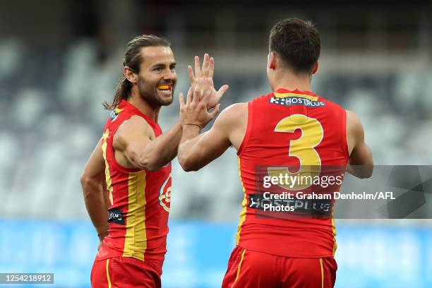 Lachie Weller of the Suns celebrates kicking a goal during the round 5 AFL match between the Geelong Cats and the Gold Coast Suns at GMHBA Stadium on...