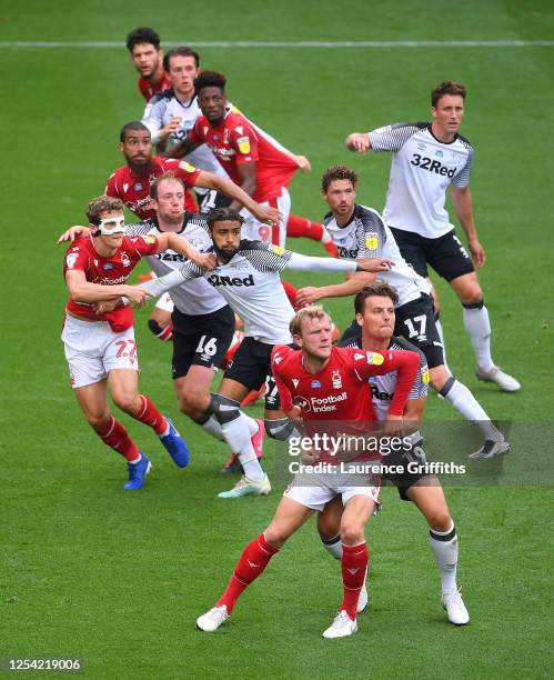 Players tussle as a cross comes into the box during the Sky Bet Championship match between Derby County and Nottingham Forest at Pride Park Stadium...