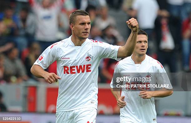 Cologne's striker Lukas Podolski celebrates after scoring during the German first division Bundesliga football match Bayer 04 Leverkusen vs 1.FC...