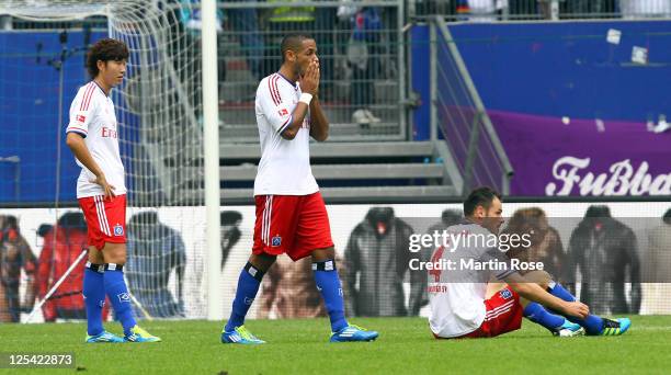 Heung Min Son, Dennis Aogo and Heiko Westermann of Hamburg look dejected after the Bundesliga match between Hamburger SV and Borussia...