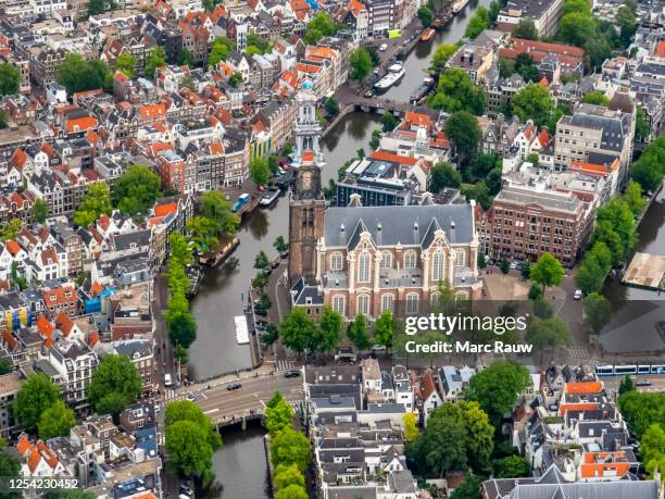 aerial photo of the westerkerk (western church) and the prinsengracht in amsterdam, the netherlands. - amsterdam aerial stock pictures, royalty-free photos & images