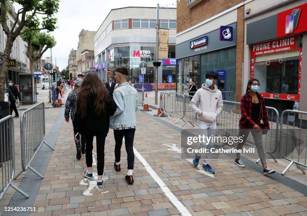 Members of the public walk through the city centre which has been marked out with social distancing markings on July 04, 2020 in Wolverhampton,...