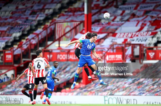 Kieffer Moore of Wigan Athletic heads the ball during the Sky Bet Championship match between Brentford and Wigan Athletic at Griffin Park on July 04,...