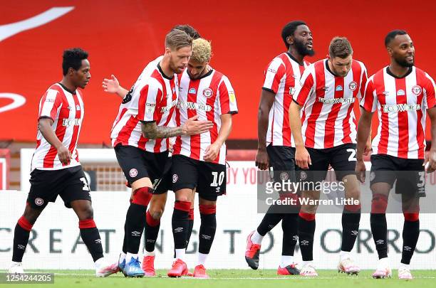 Saïd Benrahma of Brentford FC is congratulated by his captain, Pontus Jansson after completing his hattrick after scoring his third goal during the...