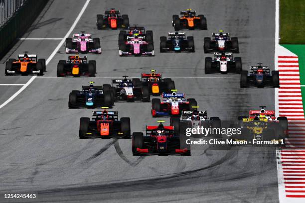 Callum Ilott of Great Britain and UNI-Virtuosi Racing drives leads Guanyu Zhou of China and UNI-Virtuosi Racing drives into turn one at the start...