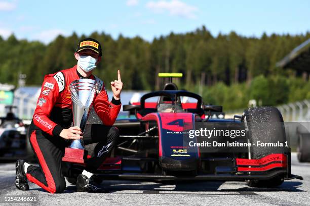 Race winner Callum Ilott of Great Britain and UNI-Virtuosi Racing celebrates on the podium during the feature race for the Formula 2 Championship at...