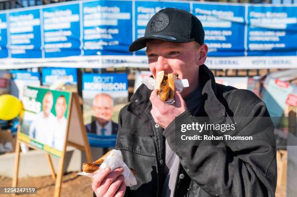 Jared Bosmans of Queanbeyan enjoying an election day sausage outside Queanbeyan West Public School on July 04, 2020 in Queanbeyan, Australia. The...