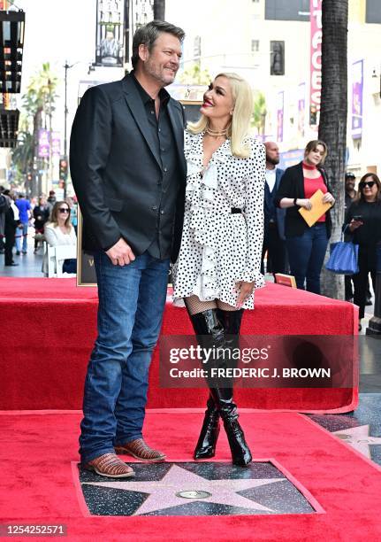 Country singer and television personality Blake Shelton and his wife US singer Gwen Stefani pose during his Hollywood Walk of Fame Star ceremony, in...