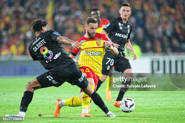 Jens Cajuste of Stade de Reims competes for the ball with Jonathan Gradit of RC Lens during the Ligue 1 match between RC Lens and Stade Reims at...