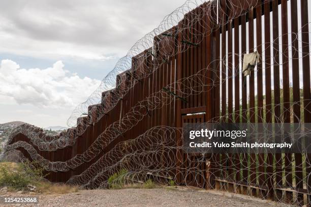 the us/mexico border fence in nogales, arizona usa - international border barrier stock pictures, royalty-free photos & images