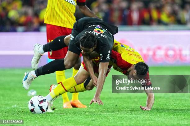 Jens Cajuste of Stade de Reims is challenged by Adrien Thomasson of RC Lens during the Ligue 1 match between RC Lens and Stade Reims at Stade...