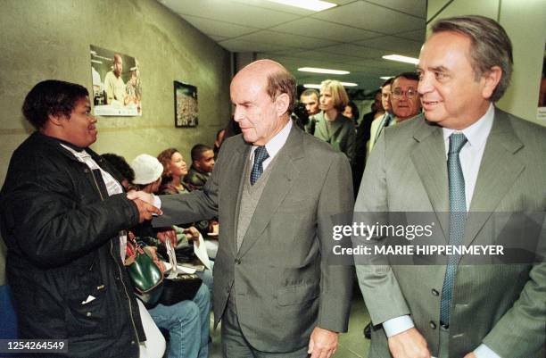 Brazilian minister of work Francisco Dornelles, center, accompanied by Argentinian colleague Jose Alberto Uriburu, right, greets a woman in the...