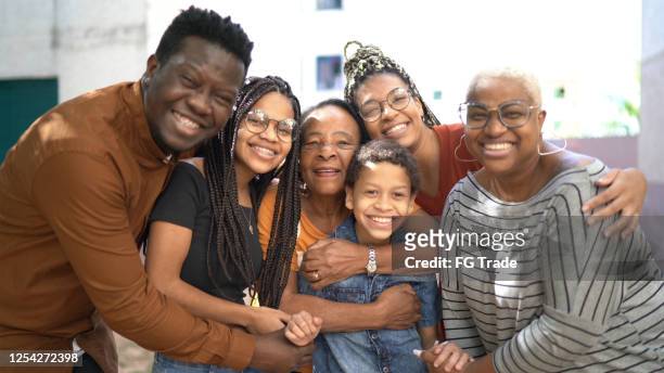 portrait of a happy family embracing outside - multi generation family stock pictures, royalty-free photos & images