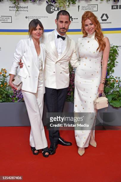Jeanne Tremsal, Clemens Schick and Palina Rojinski attend the Lola - German Film Award 2023 - red carpet arrivals at Theater am Potsdamer Platz on...