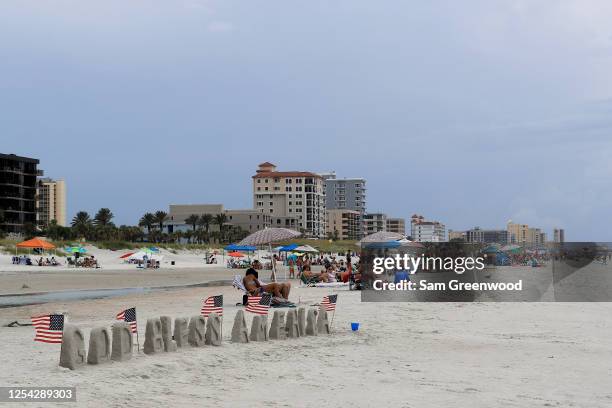 People visit Jacksonville Beach on July 04, 2020 in Jacksonville Beach, Florida. Jacksonville Beach Mayor Charlie Latham said that Duval County...