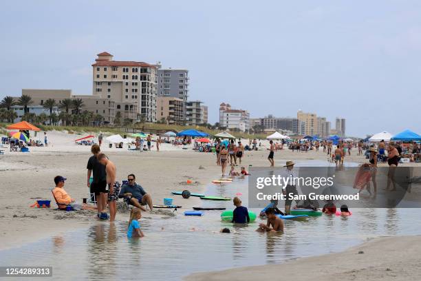 People visit Jacksonville Beach on July 04, 2020 in Jacksonville Beach, Florida. Jacksonville Beach Mayor Charlie Latham said that Duval County...