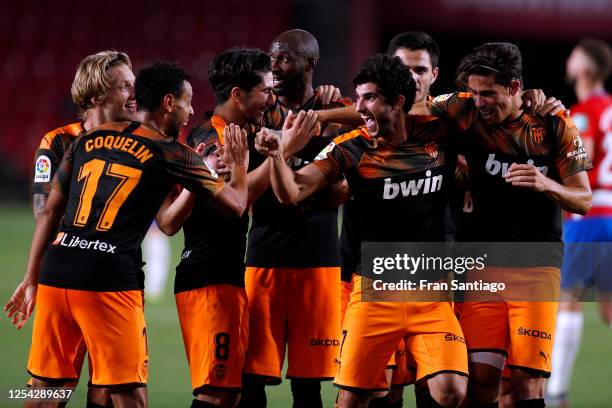 Goncalo Guedes of Valencia CF celebrates scoring his teams second goal of the game with team mates during the Liga match between Granada CF and...