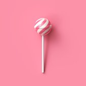 Striped fruit pink and white lollipop on stick on pink background