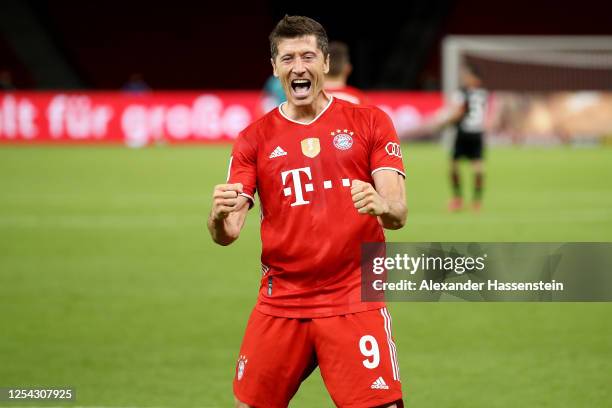 Robert Lewandowski of Bayern Muenchen celebrates scoring the 4th team goal during the DFB Cup final match between Bayer 04 Leverkusen and FC Bayern...
