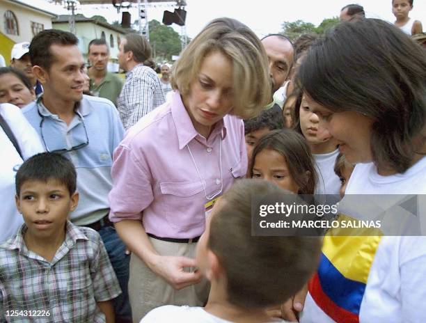 Former Colombian Foreign Minister Maria Emma Mejia speaks with children in San Vicente del Caguan, 06 January, one day before the start of peace...