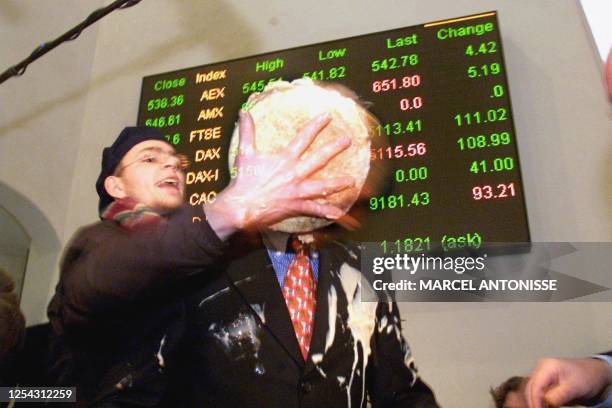 Dutch Finance Minister Gerrit Zalm gets it smack in the face as an anti-Euro demonstration makes contact with a cream cake in Amsterdam early 04th...