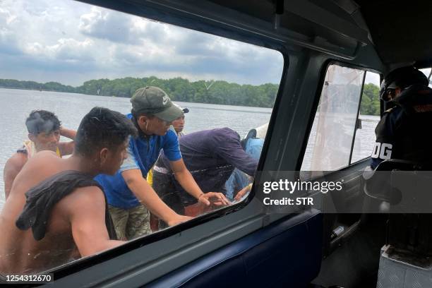 Members of the Navy request identity documents from the occupants of a vessel intercepted near the seaport of Guayaquil, Ecuador, on May 11, 2023....