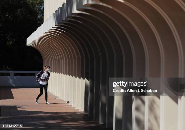 Student enters the Jack Langson Library at the University of California-Irvine in Irvine Thursday, May 11, 2023. UC Irvine is boosting student...