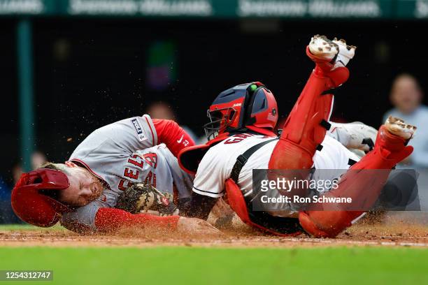 Brandon Drury of the Los Angeles Angels scores on a double by Gio Urshela as Cam Gallagher of the Cleveland Guardians attempts the tag during the...
