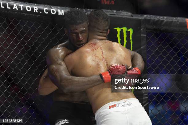 Simon Biyong and José Augusto clinch against the cage in their light heavyweight fight during the Bellator 296 event at Accor Arena on May 12, 2023...