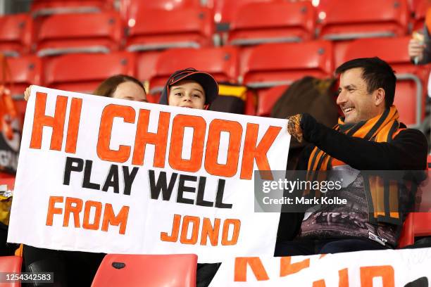 Giants supporters in the crowd hold up a banner supporting Josh Kelly during the warm-up before the round 5 AFL match between the Greater Western...