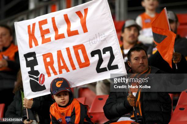 Giants supporters in the crowd hold up a banner supporting Josh Kelly during the round 5 AFL match between the Greater Western Sydney Giants and the...