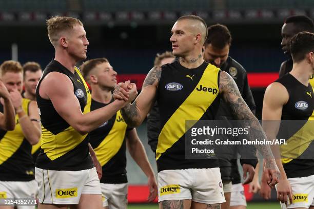 Dustin Martin of the Tigers and Josh Caddy of the Tigers celebrate victory in the round 5 AFL match between the Melbourne Demons and the Richmond...
