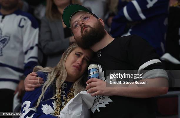 Fan is consoled as she weeps as the Toronto Maple Leafs are eliminated by the Florida Panthers in five games with a 3-2 overtime loss in the second...