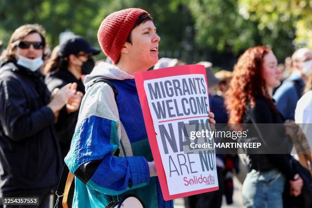 Human rights activists protest in opposition to a Stop Immigration Rally organised by The National Socialist Network outside of Parliament House in...