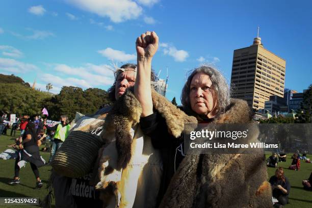 Aboriginal elders raise their arms towards the sky during a rally against Aboriginal and Torres Strait Islander deaths in custody in The Domain on...