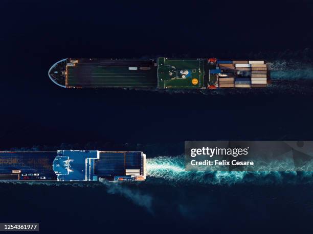 aerial view of roll-on/roll-off (roro) ships at sea. world at work drone view. - nautische ausrüstung stock-fotos und bilder