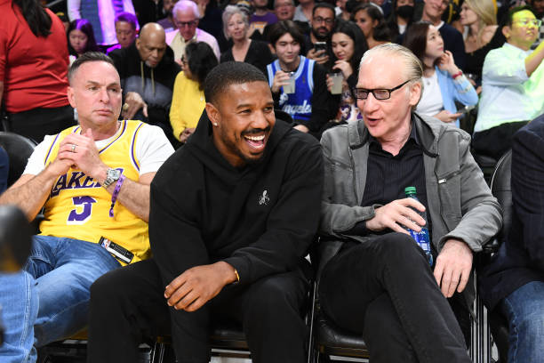 Michael B. Jordan and Bill Maher chats during in Game Six of the Western Conference Semi-Finals of the 2023 NBA Playoffs between Golden State...