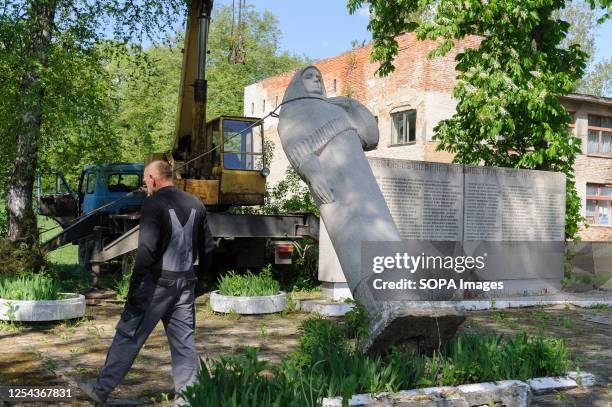 Worker dismantles a Soviet monument to a grieving mother and a bas-relief honouring Soviet soldiers who died in Word War II. Ukraine is making...