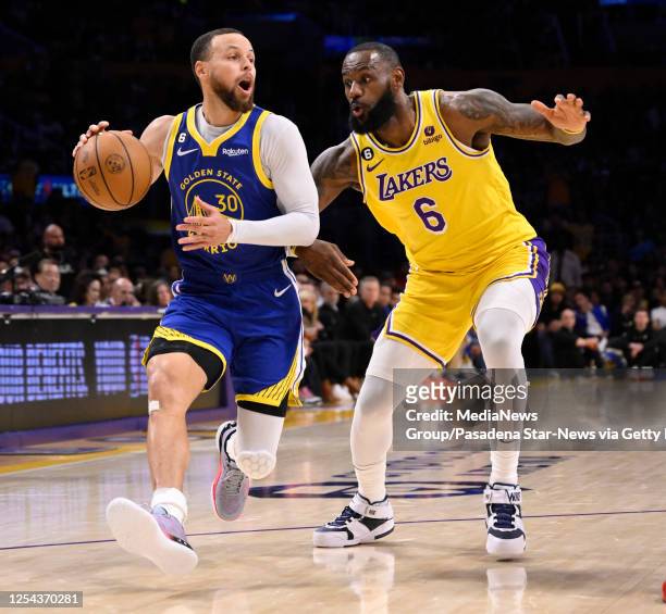 Los Angeles, CA Stephen Curry of the Golden State Warriors controls the ball against LeBron James of the Los Angeles Lakers in the first half of game...