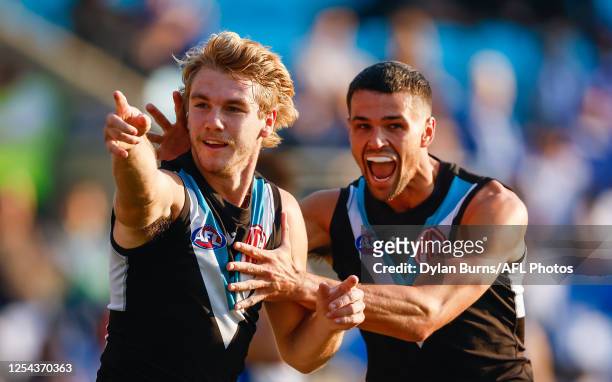 Jason Horne-Francis of the Power celebrates a goal with teammate Ryan Burton during the 2023 AFL Round 09 match between the North Melbourne Kangaroos...