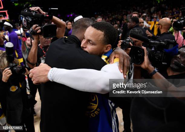 Stephen Curry of the Golden State Warriors hugs LeBron James of the Los Angeles Lakers after the Western Conference Semifinal Playoff game at...