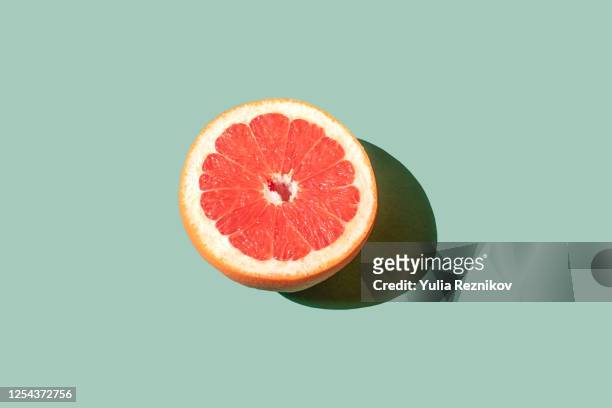 grapefruit on the green background - abstract still life stock pictures, royalty-free photos & images