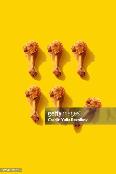 Repeated fried chicken legs on the yellow background